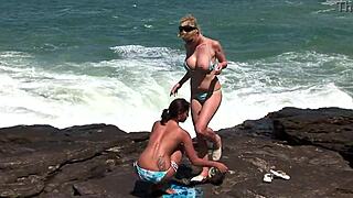 Damn, i can't stop watching these big titted brazilian lesbians lick pierced pussies on the beach for voyeurs