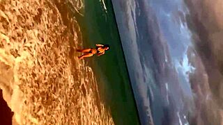 Huge tits ebony beauty urinates outdoors on a sunny beach