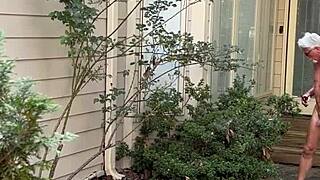 Naked man gardens outdoors again