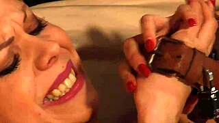 lesbian mistress orgasms from strapon while slave chained
