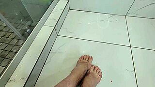Foot job on cock in morning shower