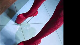 Alluring in red teaser high heels, the model poses elegantly in a tropical setting, showcasing her slender figure and confident stride during the 2023 photoshoot.