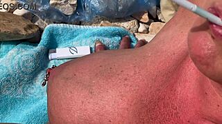 Blonde milf smokes cigarettes on the beach from day to sunset
