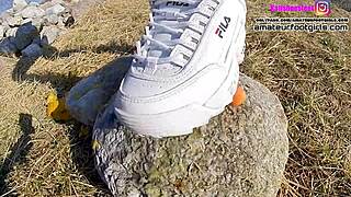 Girl teases with sweaty Fila sneakers and stinky wet nylons. She crushes and plays in sexy nylon feet.