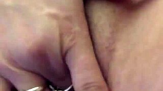 Teasing her dry pussy lips with a vibrator, contrasting sensations in intimate play.