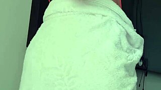 Loira shows off her BIG ASS in towel at the window for all to see