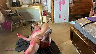 Red body paint on Sally O'Malley's curves