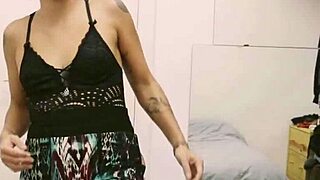 Short tattooed girl rips clothes in intense striptease.