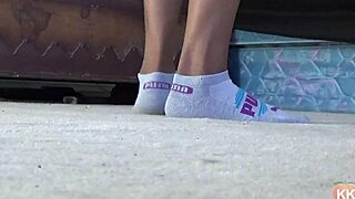 a cougar indulges in her puma socks fetish, teasing with ebony feet
