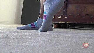 a cougar indulges in her puma socks fetish, teasing with ebony feet