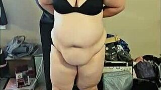 A chubby brunette amateur strips and dances sensually, ripping her clothes in a solo bbw performance