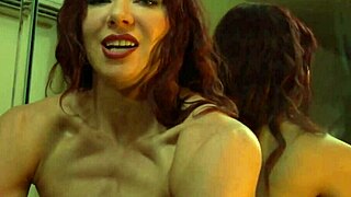 Busty redhead milf flexes her muscular body in front of the mirror