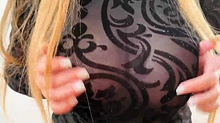 Wearing a sweatshirt that reveals large breasts and nipples