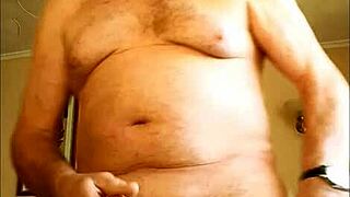 Mature woman gives handjob to hairy cock, masturbating to cumshot on homemade video