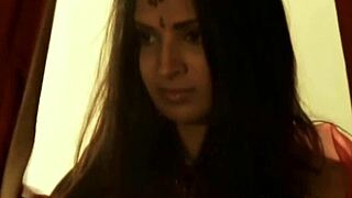 A sexy Asian belly dancer performs hot erotic dance moves