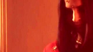 A sexy belly dancer performs with graceful moves, enjoying the moment on stage.