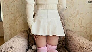 girl in a white skirt masturbates with a vibrator