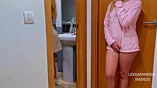 Hot blonde girl masturbates at the bathroom door.