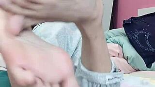 Slim gay teen indulges in foot fetish, sucking his sexy toes.