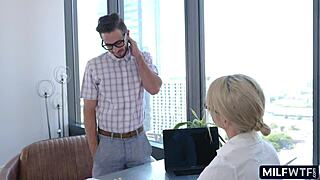 blonde milf boss in glasses dominates the office with big tits. she commands attention.
