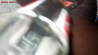 Black beauty gets her pussy pounded with a bottle