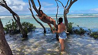 Two pretty brunettes kiss on the public beach at enseada dos corais