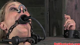 The sub is gagged and dominated by a male dom, stuffed with cock