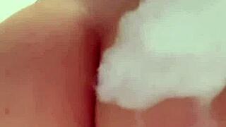 Horny British slut fingers herself in the shower