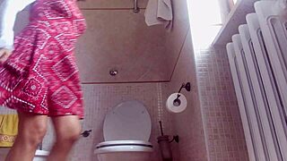 Brunette woman swears in bathroom while farting on hidden cam