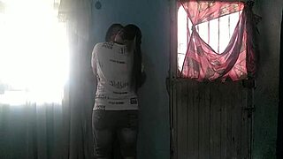 Bold brunette sneaks into neighbor's house for steamy standing lesbian sex