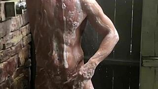 young amateur with small waist relaxes in the shower during bathing time