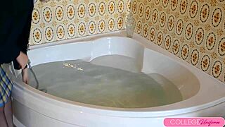 Sophia Smith dives into bathtub dressed, squirting everywhere.