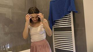 Look at this braless hot brunette babe in pink mini skirt showing her ass and legs in the bathroom?