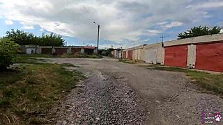 Student enjoys liquid lunch behind garages