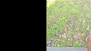tall black woman stomps in garden, everything looks small from up here