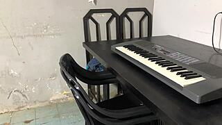 Curvy young woman shakes big ass in tight skirt during keyboard lessons in dorm room