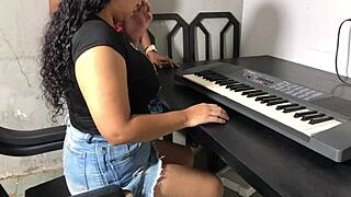 Curvy young woman shakes big ass in tight skirt during keyboard lessons in dorm room