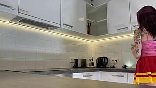 Look at this hottest redhead cheerleader flashing her see-through panties in the kitchen!