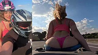 Blonde beauty rides motorcycle on highway