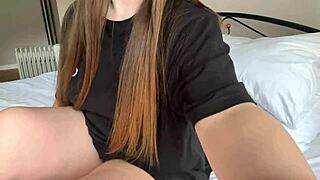 In her black t-shirt, the cute girl fingers her pussy until she cums.