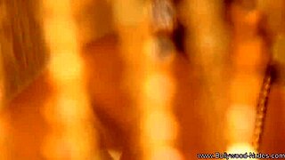 brunette indian woman performs erotic dance to arouse with teasing striptease