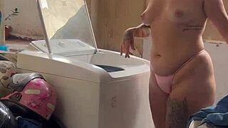 woman washes clothes freely with pussy and tits out