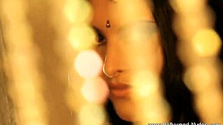 brunette indian woman performs erotic dance to arouse with teasing striptease