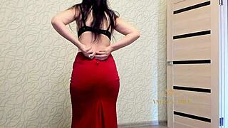 Beautiful dark-haired MILF dances sensually, slowly undressing for fans