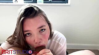 Young curvy British teen with blue eyes and long hair wears polo shirt. She enjoys public outdoor activity with neighbor.