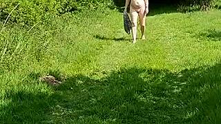 A naughty girl walks naked at the botanical gardens in public outdoor setting