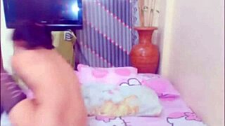 The performer demonstrates a self-sucking technique in an amateur setting