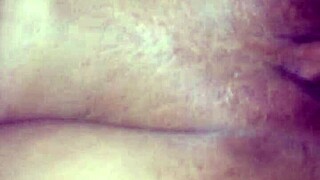In the dimly lit room, an interracial couple engages in passionate sex, her pussy growing wet with desire.