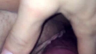 In the dimly lit room, an interracial couple engages in passionate sex, her pussy growing wet with desire.