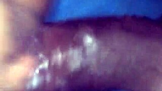 In the dimly lit room, an interracial couple engages in passionate sex, her pussy growing wet with desire.